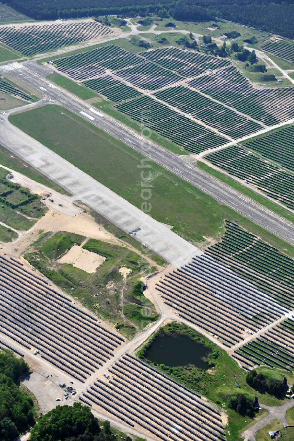 Aerial photograph Eberswalde - Finowfurt - View of the almost fully assembled solar fields of the new solar power plant Finow Tower. The hybrid solar AG is currently building on the former military airport, a solar power plant