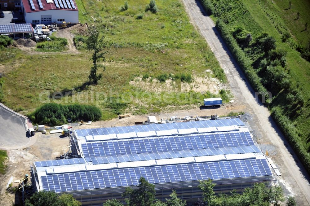 Aerial photograph Großostheim OT Ringheim - Großostheim 07/23/2012 view of a photovoltaic / solar power plant as a combination of open spaces and roof systems in the industrial park Großostheim in state of Bavaria. A project of Conecon GmbH