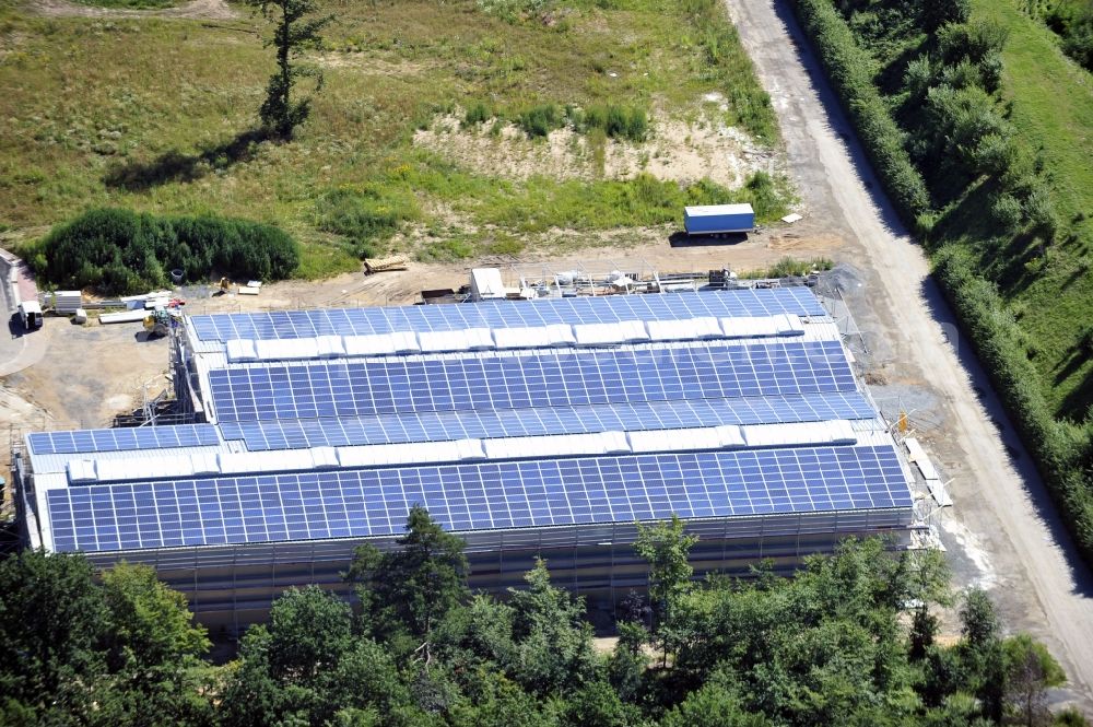 Großostheim OT Ringheim from above - Großostheim 07/23/2012 view of a photovoltaic / solar power plant as a combination of open spaces and roof systems in the industrial park Großostheim in state of Bavaria. A project of Conecon GmbH