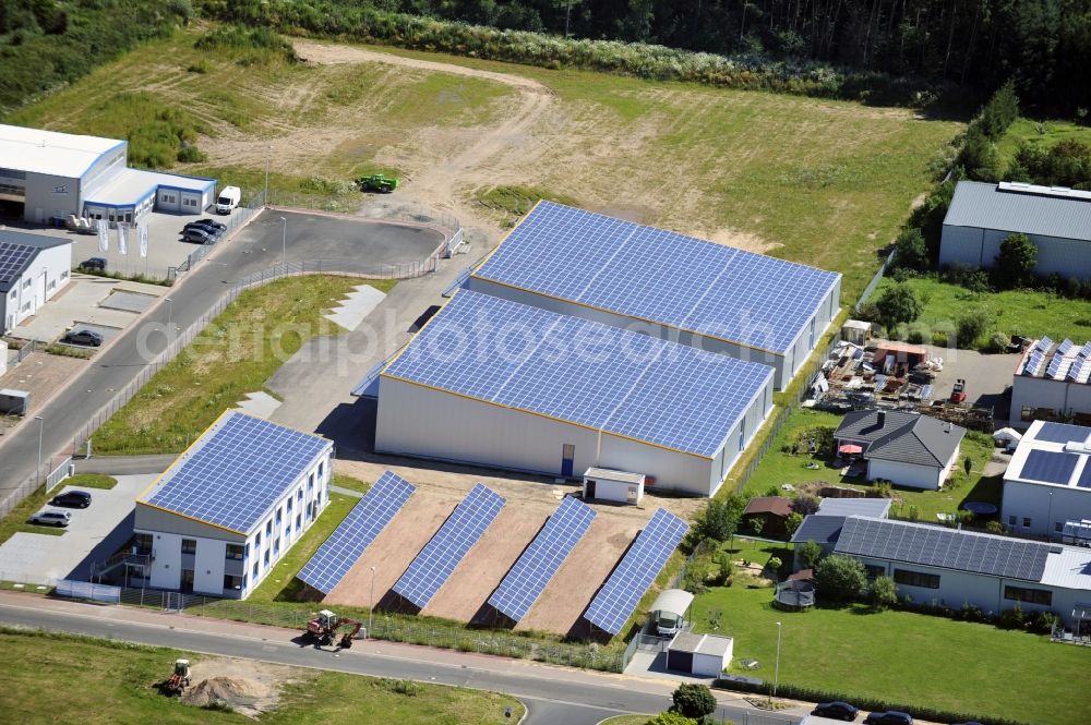 Großostheim OT Ringheim from the bird's eye view: Großostheim 07/23/2012 view of a photovoltaic / solar power plant as a combination of open spaces and roof systems in the industrial park Großostheim in state of Bavaria. A project of Conecon GmbH