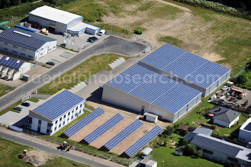 Aerial photograph Großostheim OT Ringheim - Großostheim 07/23/2012 view of a photovoltaic / solar power plant as a combination of open spaces and roof systems in the industrial park Großostheim in state of Bavaria. A project of Conecon GmbH