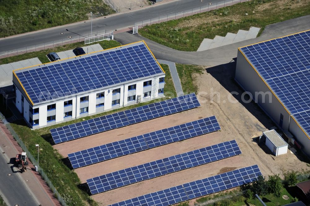 Großostheim OT Ringheim from above - Großostheim 07/23/2012 view of a photovoltaic / solar power plant as a combination of open spaces and roof systems in the industrial park Großostheim in state of Bavaria. A project of Conecon GmbH