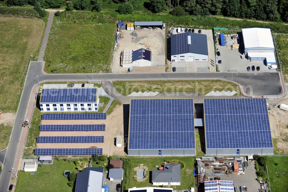 Großostheim OT Ringheim from above - Großostheim 07/23/2012 view of a photovoltaic / solar power plant as a combination of open spaces and roof systems in the industrial park Großostheim in state of Bavaria. A project of Conecon GmbH