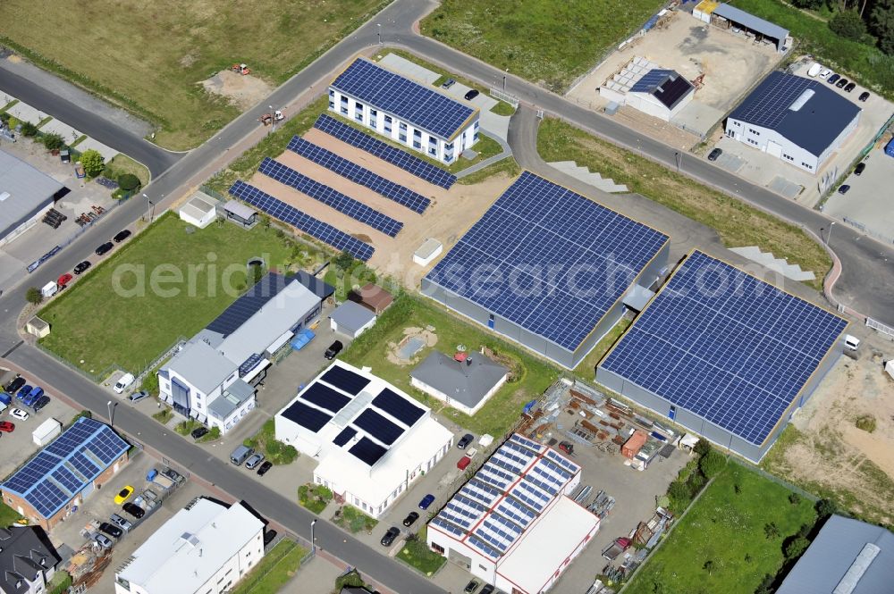 Aerial image Großostheim OT Ringheim - Großostheim 07/23/2012 view of a photovoltaic / solar power plant as a combination of open spaces and roof systems in the industrial park Großostheim in state of Bavaria. A project of Conecon GmbH