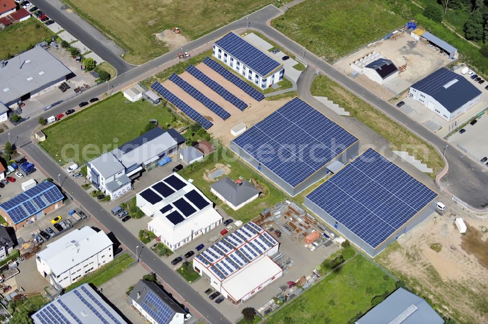 Aerial photograph Großostheim OT Ringheim - Großostheim 07/23/2012 view of a photovoltaic / solar power plant as a combination of open spaces and roof systems in the industrial park Großostheim in state of Bavaria. A project of Conecon GmbH