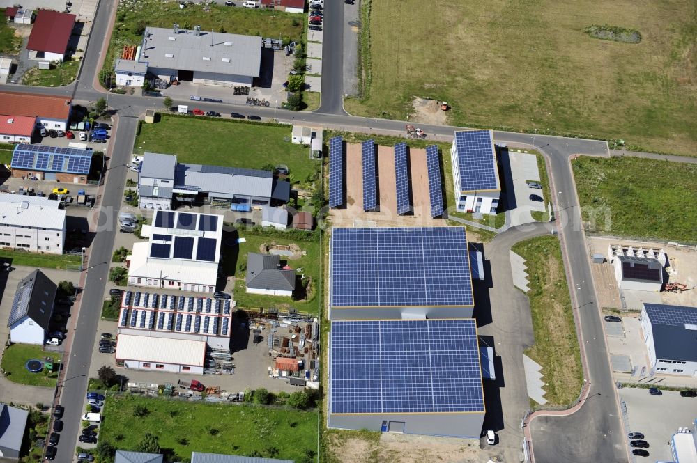 Großostheim OT Ringheim from the bird's eye view: Großostheim 07/23/2012 view of a photovoltaic / solar power plant as a combination of open spaces and roof systems in the industrial park Großostheim in state of Bavaria. A project of Conecon GmbH