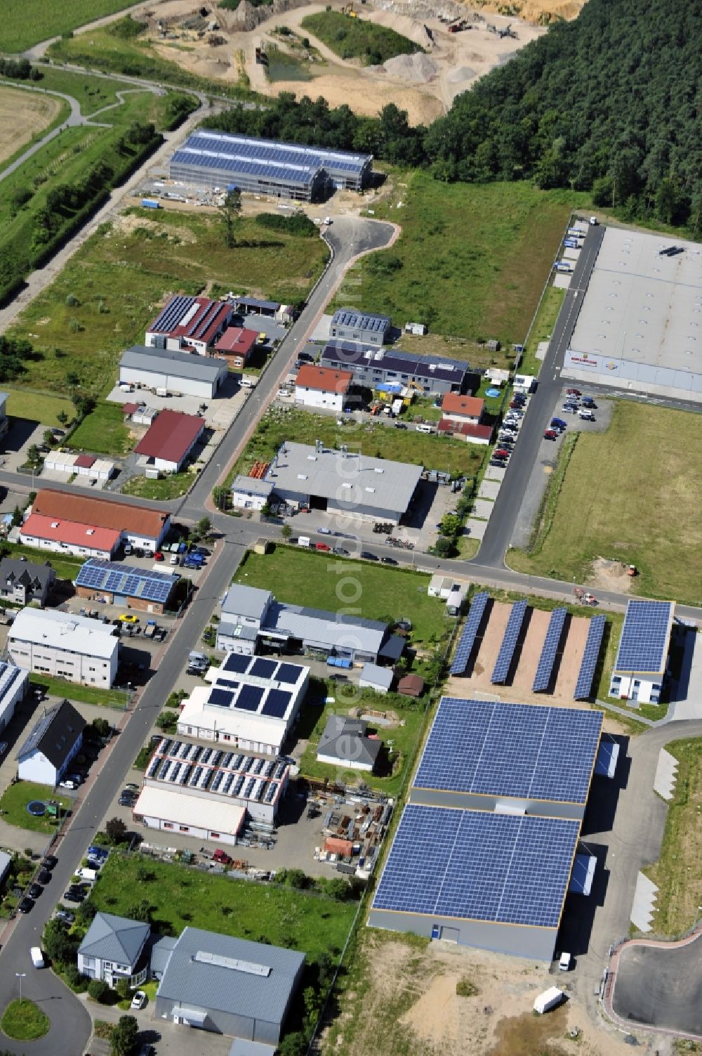 Aerial image Großostheim OT Ringheim - Großostheim 07/23/2012 view of a photovoltaic / solar power plant as a combination of open spaces and roof systems in the industrial park Großostheim in state of Bavaria. A project of Conecon GmbH