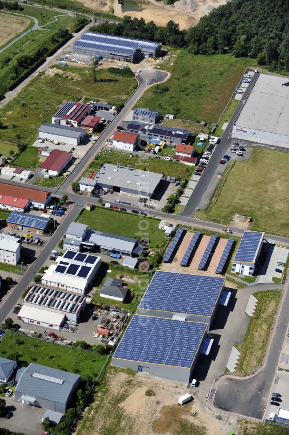 Aerial photograph Großostheim OT Ringheim - Großostheim 07/23/2012 view of a photovoltaic / solar power plant as a combination of open spaces and roof systems in the industrial park Großostheim in state of Bavaria. A project of Conecon GmbH