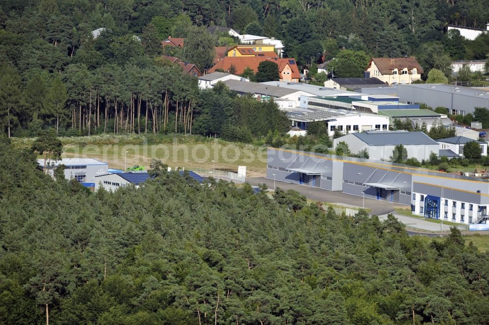 Großostheim OT Ringheim from the bird's eye view: Großostheim 07/23/2012 view of a photovoltaic / solar power plant as a combination of open spaces and roof systems in the industrial park Großostheim in state of Bavaria. A project of Conecon GmbH