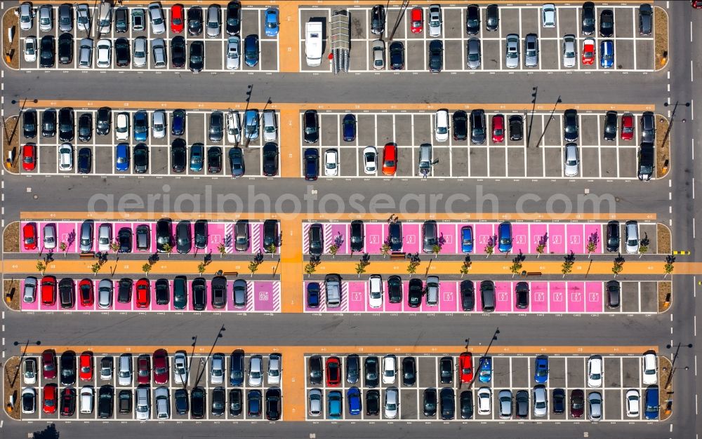 Bochum from the bird's eye view: Hot pink color-coded rows of women parking and disabled parking spaces in the parking lot for automobiles at the Ruhr Park shopping center in Bochum in North Rhine-Westphalia