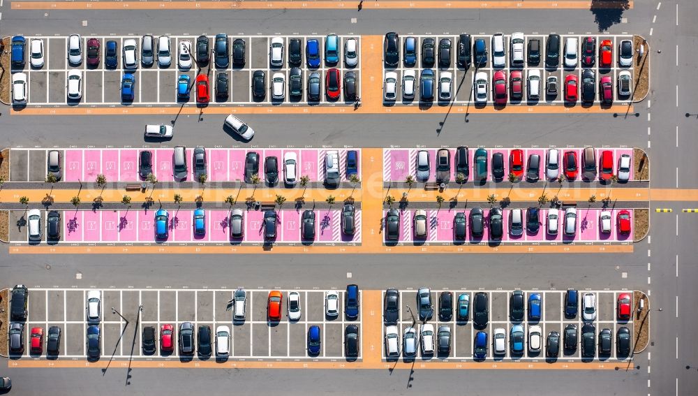 Bochum from the bird's eye view: Hot pink color-coded rows of women parking and disabled parking spaces in the parking lot for automobiles at the Ruhr Park shopping center in Bochum in North Rhine-Westphalia
