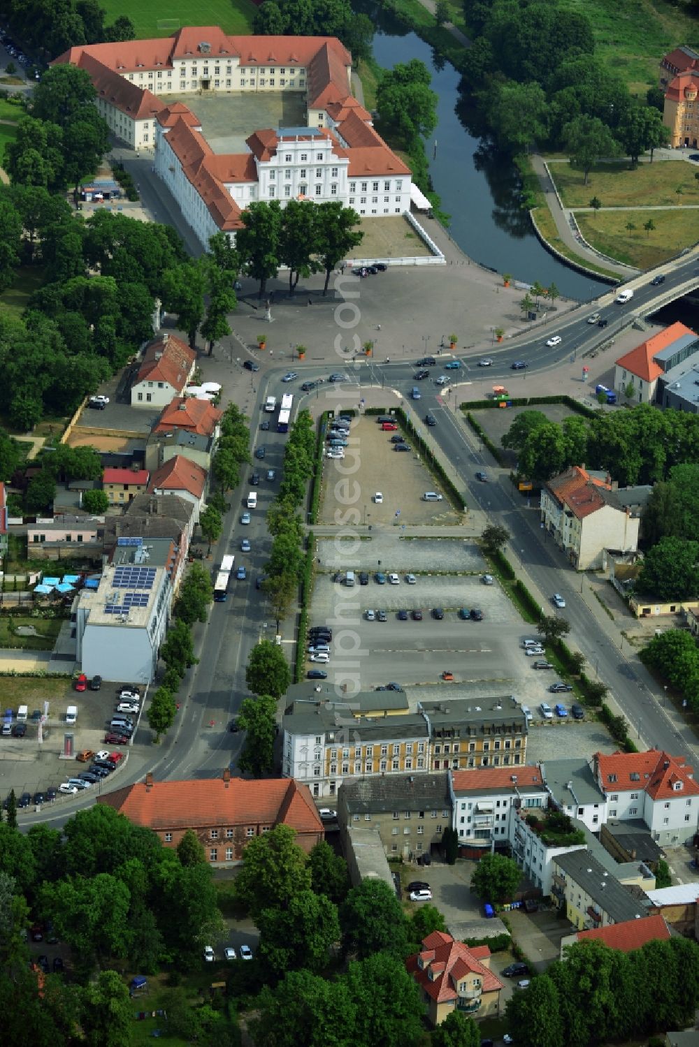 Aerial photograph Oranienburg - Automobile and automotive parking- area in Oranienburg in the state Brandenburg. GVG Project Development Company plans on open-space land an urban development with a local supply and service center