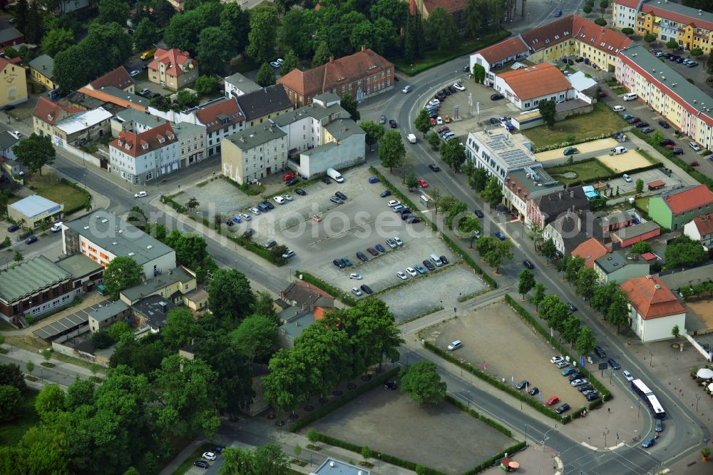 Aerial photograph Oranienburg - Automobile and automotive parking- area in Oranienburg in the state Brandenburg. GVG Project Development Company plans on open-space land an urban development with a local supply and service center