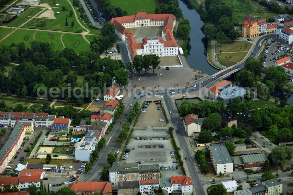 Oranienburg from the bird's eye view: Automobile and automotive parking- area in Oranienburg in the state Brandenburg. GVG Project Development Company plans on open-space land an urban development with a local supply and service center