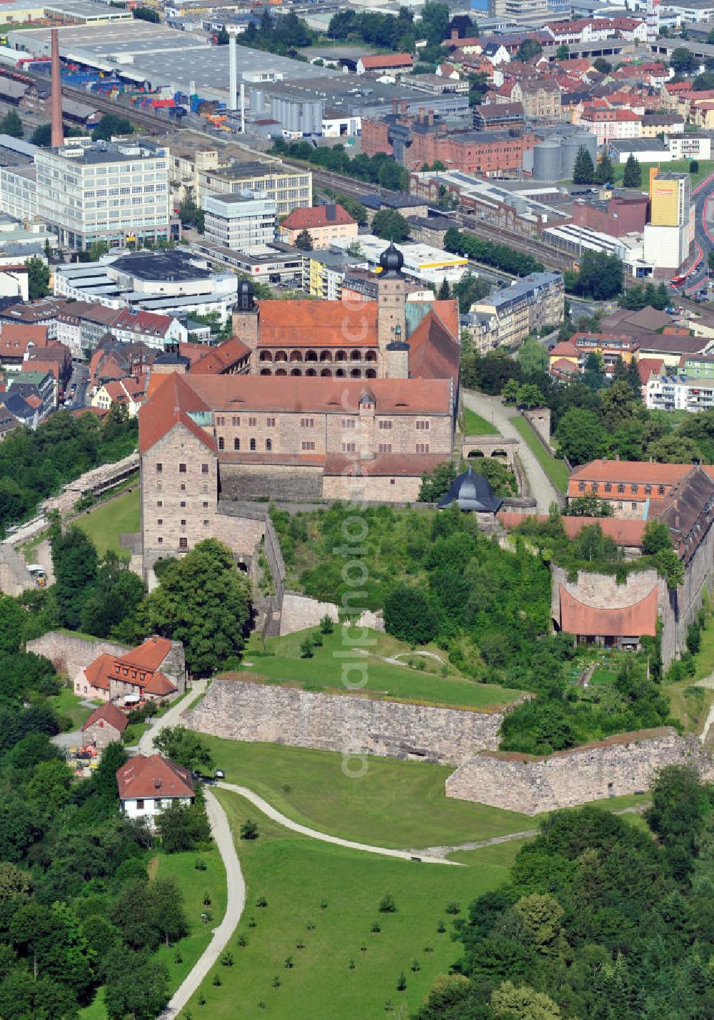 Kulmbach from the bird's eye view: Die Plassenburg in Kulmbach, Bayern. Aufgrund ihrer militärischen Stärke und künstlerischen Ausgestaltung genoss die Burganlage in früheren Jahrhunderten einen fast legendären Ruf. Im dritten Reich beherbergte sie die Reichsschule der deutschen Technik, heutzutage befinden sich hier das staatliche Museum Die Hohenzollern in Franken , das Armeemuseum Friedrich der Große, das Landschaftsmuseum Obermain und das Deutsche Zinnfigurenmuseum. Desweiteren finden auf dem Gelände immer wieder Ausstellungen statt. Es befindet sich im Besitz des Freistaats Bayern. Castle Plassenburg in Kulmbach, Bavaria. Several museums are located here.