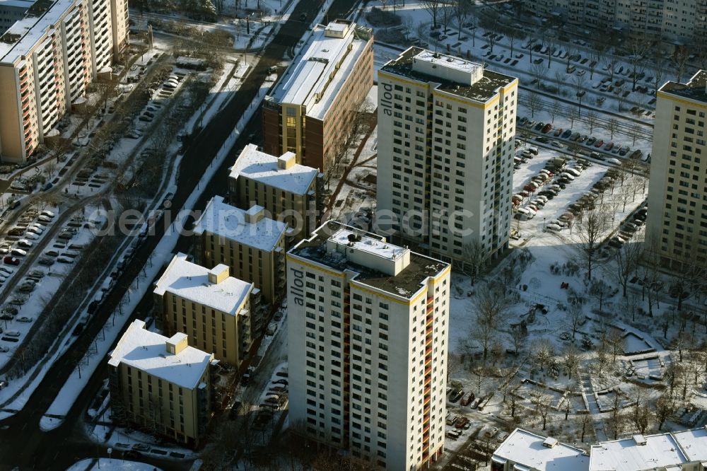 Aerial photograph Berlin - Winterly snowy highrise buildings in the residential area of a industrially manufactured settlement allod GmbH & Co. KG destrict Marzahn in Berlin in Germany