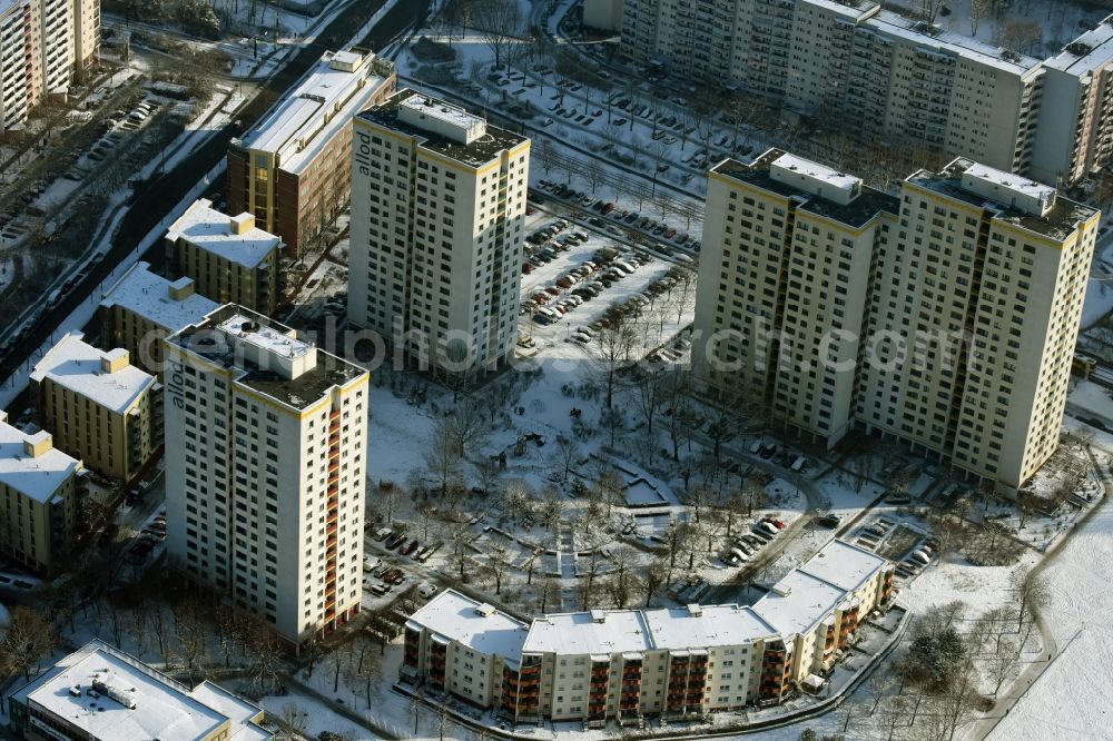 Berlin from above - Winterly snowy highrise buildings in the residential area of a industrially manufactured settlement allod GmbH & Co. KG destrict Marzahn in Berlin in Germany