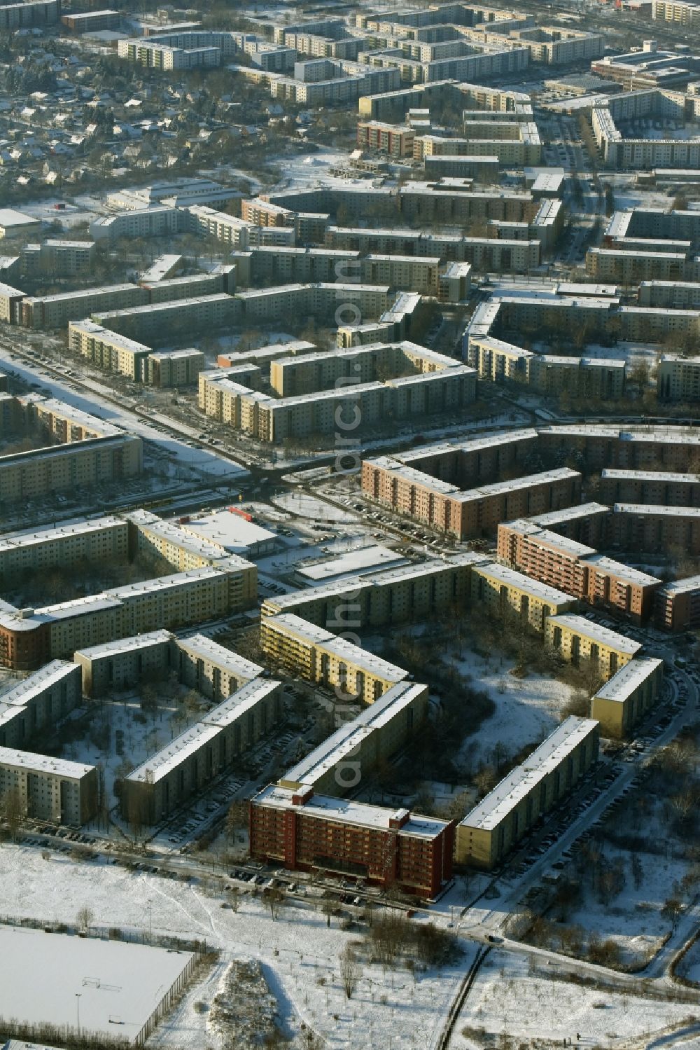 Berlin from above - Winterly and snowy high-rise buildings in the residential area of a industrially manufactured settlement near the roads Mark-Twain-Strasse and Riesaer-Strasse in Hellersdorf in berlin in Germany