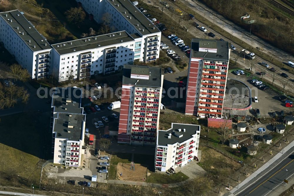 Berlin from above - Winterly snowy high-rise buildings in the residential area of industrially manufactured settlement RHIN TOWERS - ABCEK Immobilienmanagement GmbH besides the road Hellersdorfer Strasse in Berlin in Germany