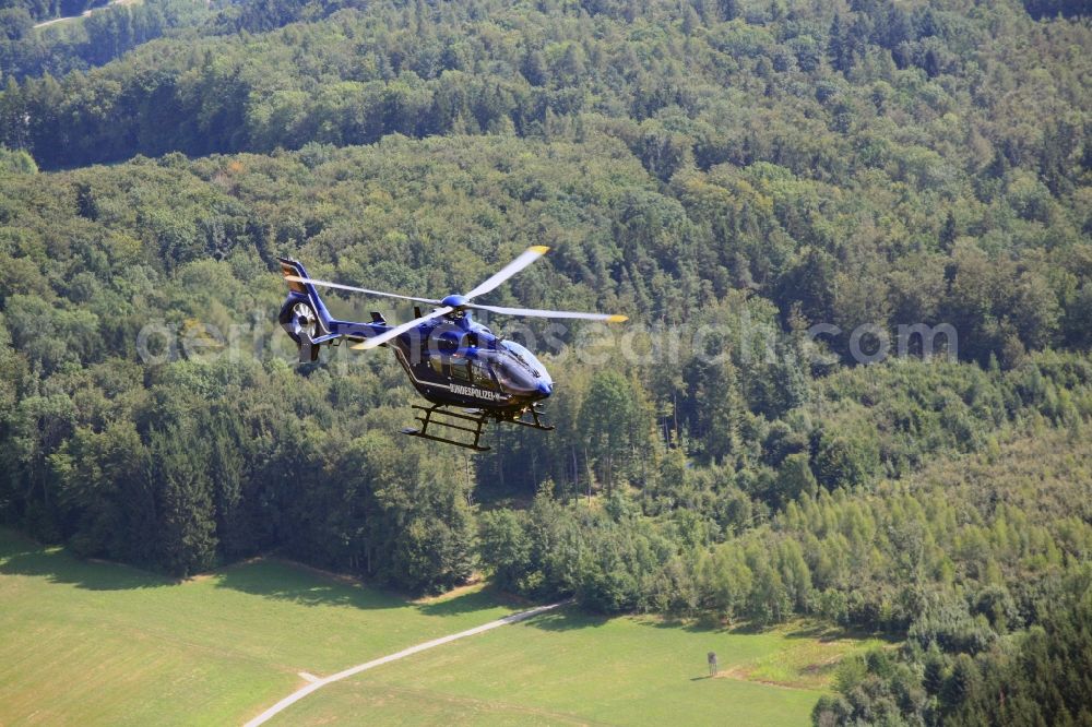 Rheinfelden (Baden) from the bird's eye view: Helicopter in flight EC 135 of federal police mission D-HVBD over the air space in Rheinfelden (Baden) in the state Baden-Wuerttemberg