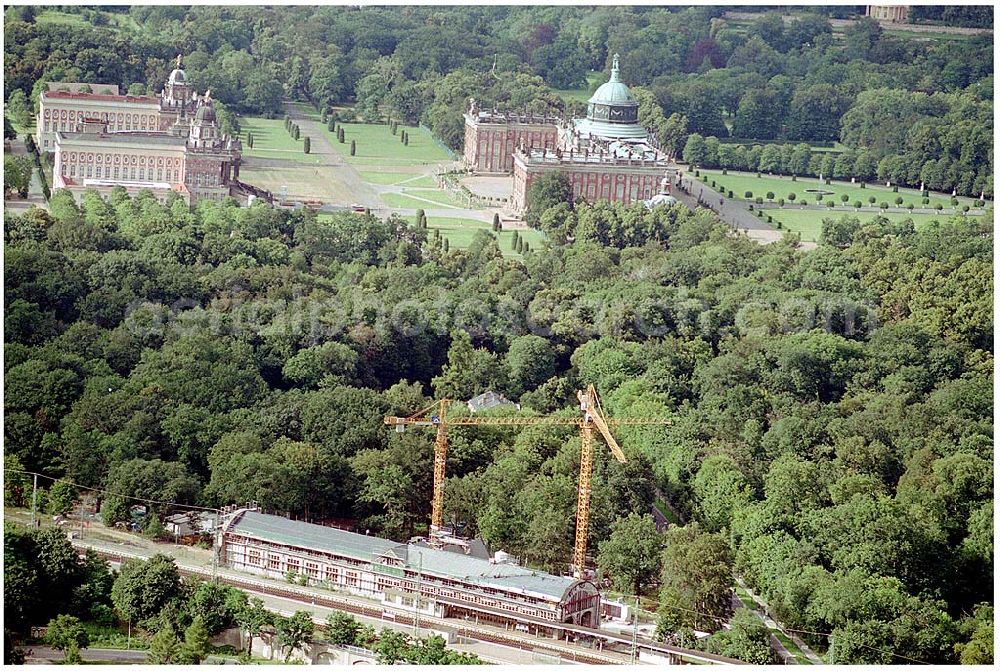 Potsdam from the bird's eye view: 27.07.2004 Blick auf den Potsdamer Kaiserbahnhof sowie im Hintergrund das Neue Palais und der Triumphbogen mit dem Ensemble der Communs. Der 1999 in die Unesco-Welterbeliste aufgenommene Kaiserbahnhof des letzten deutschen Kaisers Friedrich Wilhelm II. wird nach langem Verfall zur Führungskräfteakademie der Deutschen Bahn AG ausgebaut. Bauherr: Deutsche Bahn Akademie GmbH, vertreten durch DB Station und Service architektur:büro für bausanierung + denkmalpflege Richard - Sorge - Straße 25, Berlin