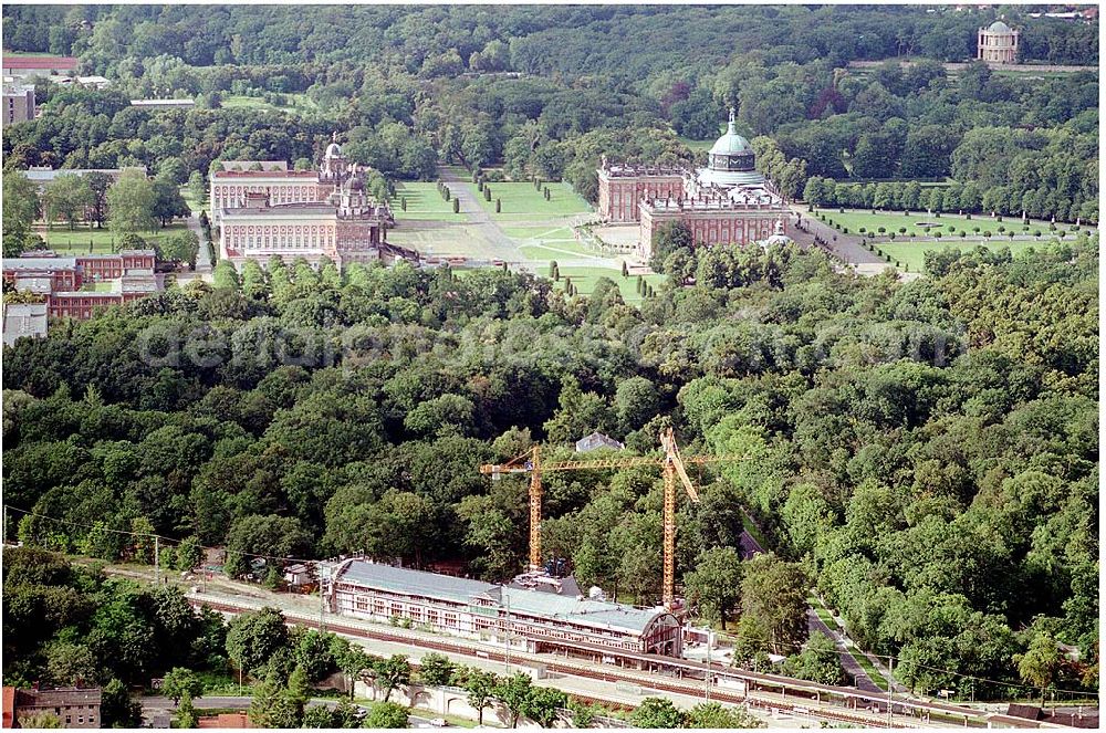 Aerial image Potsdam - 27.07.2004 Blick auf den Potsdamer Kaiserbahnhof sowie im Hintergrund das Neue Palais und der Triumphbogen mit dem Ensemble der Communs. Der 1999 in die Unesco-Welterbeliste aufgenommene Kaiserbahnhof des letzten deutschen Kaisers Friedrich Wilhelm II. wird nach langem Verfall zur Führungskräfteakademie der Deutschen Bahn AG ausgebaut. Bauherr: Deutsche Bahn Akademie GmbH, vertreten durch DB Station und Service architektur:büro für bausanierung + denkmalpflege Richard - Sorge - Straße 25, Berlin