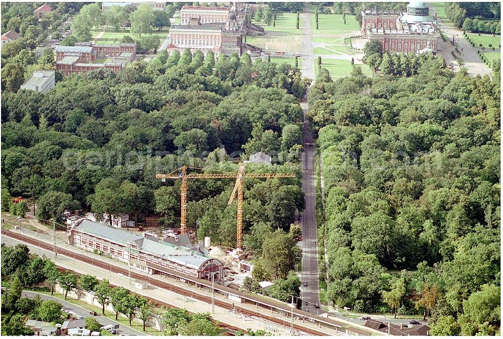 Aerial photograph Potsdam - 27.07.2004 Blick auf den Potsdamer Kaiserbahnhof sowie im Hintergrund das Neue Palais und der Triumphbogen mit dem Ensemble der Communs. Der 1999 in die Unesco-Welterbeliste aufgenommene Kaiserbahnhof des letzten deutschen Kaisers Friedrich Wilhelm II. wird nach langem Verfall zur Führungskräfteakademie der Deutschen Bahn AG ausgebaut. Bauherr: Deutsche Bahn Akademie GmbH, vertreten durch DB Station und Service architektur:büro für bausanierung + denkmalpflege Richard - Sorge - Straße 25, Berlin