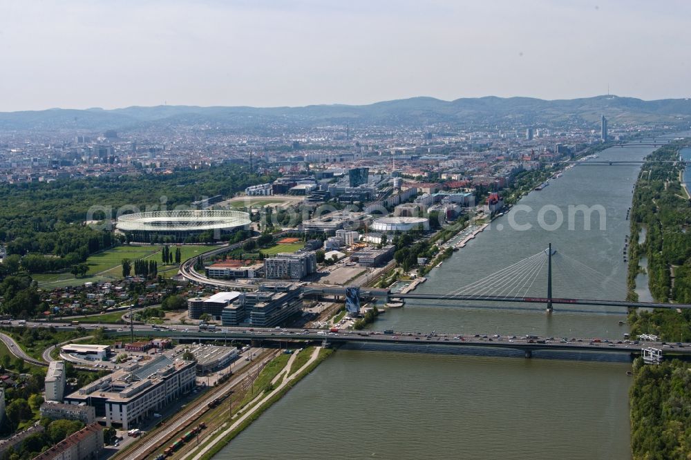 Aerial photograph Wien - View of the Prater bridge, the parallel running railway bridge and the river bank of the Danube in Vienna in Austria. Over the bridge the Suedosttangente runs and along the bank the Handelskai. Further away the Ernst-Happel-Stadium is visible