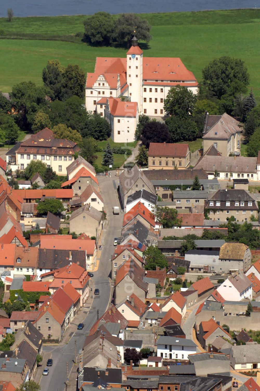 Bad Schmiedeberg from the bird's eye view: Pretzsch (Elbe) war bis zum 30. Juni 2009 eine selbständige Stadt und ist seitdem ein Ortsteil der Stadt Bad Schmiedeberg im Landkreis Wittenberg in Sachsen-Anhalt. Der Ort liegt am Westufer der Elbe am nordwestlichen Rand des Naturparkes Dübener Heide. Im Bild das Renaissanceschloss aus dem 16. Jahrhundert. Schloss und Garten gehören zum Netzwerk Gartenträume Sachsen-Anhalt. Die Kirche links davon, die Stadtkirche St. Nikolaus, ist eine spätgotische Kirche mit barocken Umbauten unter Matthäus Daniel Pöppelmann.