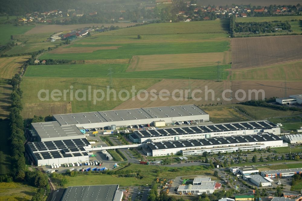 Nauen from the bird's eye view: Production facilities and company buildings of BSH House machines Nauen GmbH in Nauen in the state of Brandenburg. The works include a cargo and logistics centre. The site is located on the edge of a field