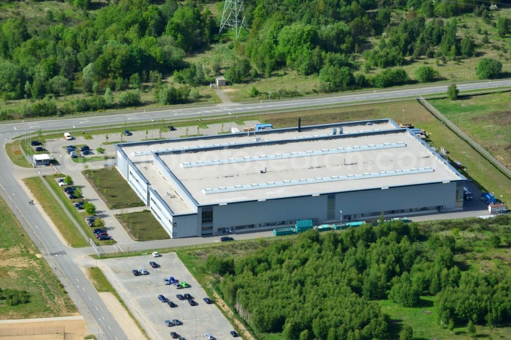 Schwerin from the bird's eye view: Production site of Flamm Group in the Industrial Park Schwerin in Schwerin in the state of Mecklenburg - Western Pomerania. The newly developed industrial and commercial area is currently under construction in a forest area in the South of Schwerin. Some buildings - such as the new works of the metal manufacturer for the aviation and aerospace industry - are already in use