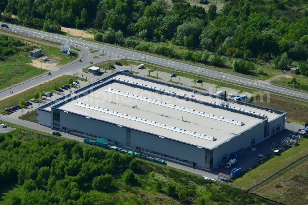 Schwerin from above - Production site of Flamm Group in the Industrial Park Schwerin in Schwerin in the state of Mecklenburg - Western Pomerania. The newly developed industrial and commercial area is currently under construction in a forest area in the South of Schwerin. Some buildings - such as the new works of the metal manufacturer for the aviation and aerospace industry - are already in use