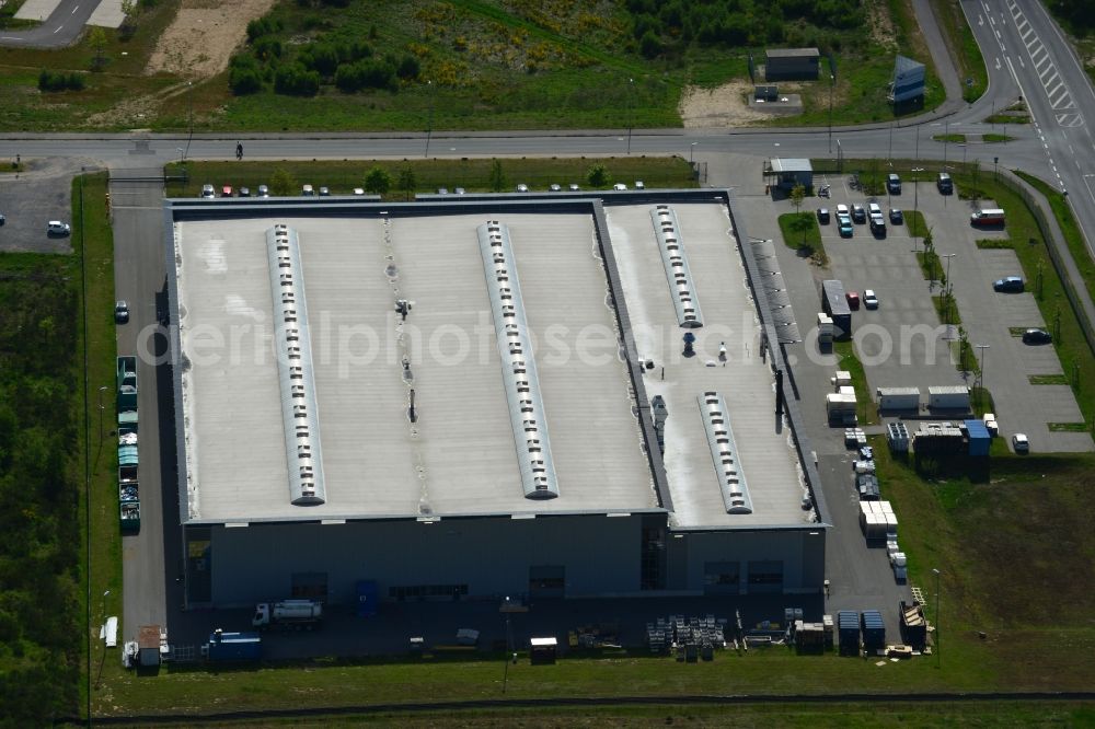 Aerial photograph Schwerin - Production site of Flamm Group in the Industrial Park Schwerin in Schwerin in the state of Mecklenburg - Western Pomerania. The newly developed industrial and commercial area is currently under construction in a forest area in the South of Schwerin. Some buildings - such as the new works of the metal manufacturer for the aviation and aerospace industry - are already in use