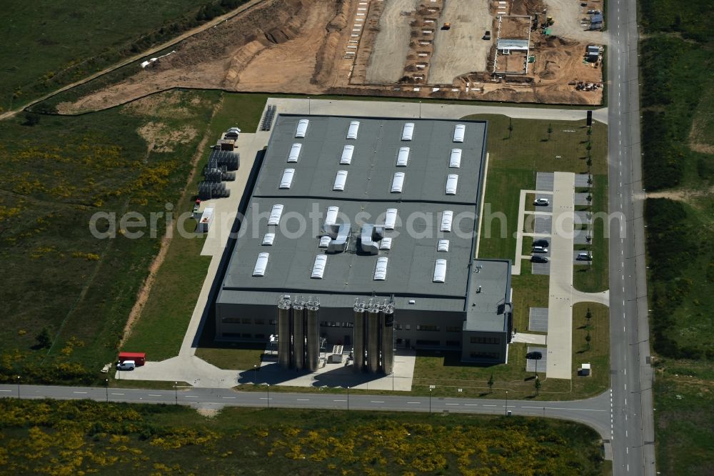 Aerial photograph Schwerin - Production site of Procap in the Industrial Park Schwerin in Schwerin in the state of Mecklenburg - Western Pomerania. The newly developed industrial and commercial area is currently under construction in a forest area in the South of Schwerin. Some buildings - such as the new works of the plastics manufacturer - are already in use