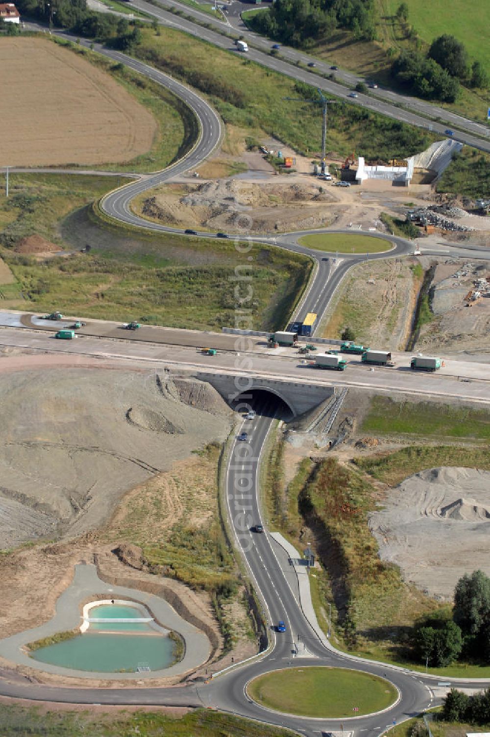 Aerial photograph Eisenach - Blick auf die Baustelle der Ausfahrt / Anschlussstelle Eisenach-West der A4. Der Neubau ist Teil des Projekt Nordverlegung / Umfahrung Hörselberge der Autobahn E40 / A4 in Thüringen bei Eisenach. Durchgeführt werden die im Zuge dieses Projektes notwendigen Arbeiten unter an derem von den Mitarbeitern der Niederlassung Weimar der EUROVIA Verkehrsbau Union sowie der Niederlassungen Abbruch und Erdbau, Betonstraßenbau, Ingenieurbau und TECO Schallschutz der EUROVIA Beton sowie der DEGES.