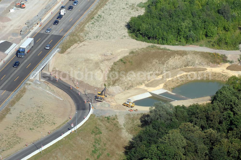 Eisenach from above - Blick auf die Baustelle einer Unterführung der A4 mit Regenrückhaltebecken westlich der Raststätte Eisenach. Der Neubau ist Teil des Projekt Nordverlegung / Umfahrung Hörselberge der Autobahn E40 / A4 in Thüringen bei Eisenach. Durchgeführt werden die im Zuge dieses Projektes notwendigen Arbeiten unter an derem von den Mitarbeitern der Niederlassung Weimar der EUROVIA Verkehrsbau Union sowie der Niederlassungen Abbruch und Erdbau, Betonstraßenbau, Ingenieurbau und TECO Schallschutz der EUROVIA Beton sowie der DEGES.