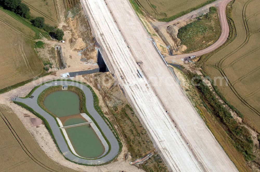 Aerial image Hötzelsroda - Blick auf die Baustelle einer Unterführung der A4 mit Regenrückhaltebecken östlich von Hötzelsroda. Der Neubau ist Teil des Projekt Nordverlegung / Umfahrung Hörselberge der Autobahn E40 / A4 in Thüringen bei Eisenach. Durchgeführt werden die im Zuge dieses Projektes notwendigen Arbeiten unter an derem von den Mitarbeitern der Niederlassung Weimar der EUROVIA Verkehrsbau Union sowie der Niederlassungen Abbruch und Erdbau, Betonstraßenbau, Ingenieurbau und TECO Schallschutz der EUROVIA Beton sowie der DEGES.