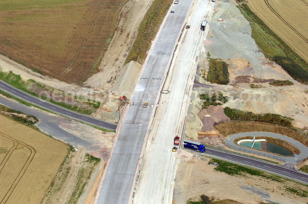 Neukirchen from the bird's eye view: Blick auf die Baustelle einer Unterführung der A4 für die Strassenverbindung zwischen Stregda und Neukirchen, sowie ein Regenrückhaltebecken. Der Neubau ist Teil des Projekt Nordverlegung / Umfahrung Hörselberge der Autobahn E40 / A4 in Thüringen bei Eisenach. Durchgeführt werden die im Zuge dieses Projektes notwendigen Arbeiten unter an derem von den Mitarbeitern der Niederlassung Weimar der EUROVIA Verkehrsbau Union sowie der Niederlassungen Abbruch und Erdbau, Betonstraßenbau, Ingenieurbau und TECO Schallschutz der EUROVIA Beton sowie der DEGES.