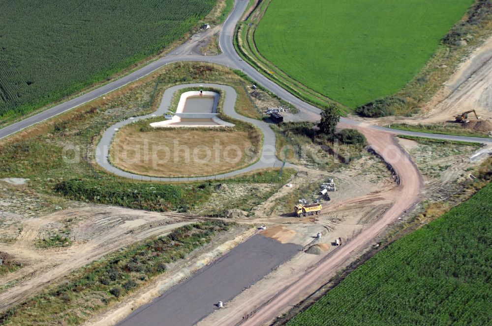 Aerial photograph Sättelstädt - Blick auf die Baustelle der Ausfahrt / Anschlussstelle Sättelstädt der A4 mit Regenrückhaltebecken VI und neuer Strassenbrücke. Der Neubau ist Teil des Projekt Nordverlegung / Umfahrung Hörselberge der Autobahn E40 / A4 in Thüringen bei Eisenach. Durchgeführt werden die im Zuge dieses Projektes notwendigen Arbeiten unter an derem von den Mitarbeitern der Niederlassung Weimar der EUROVIA Verkehrsbau Union sowie der Niederlassungen Abbruch und Erdbau, Betonstraßenbau, Ingenieurbau und TECO Schallschutz der EUROVIA Beton sowie der DEGES.