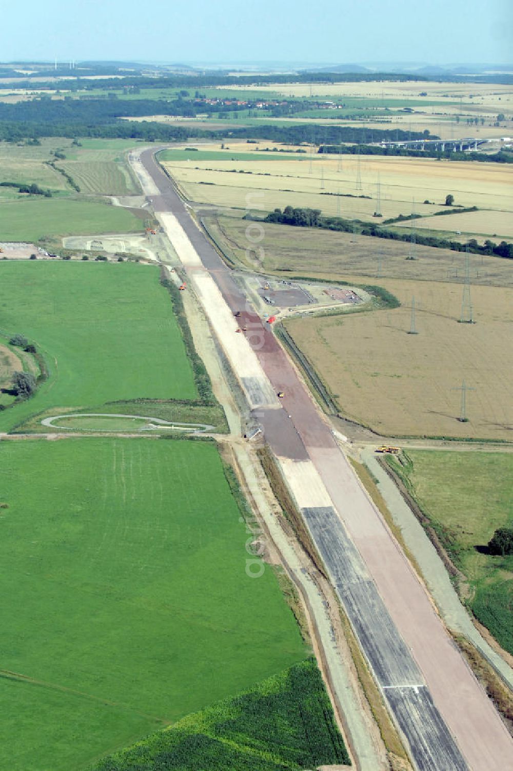 Aerial image Wenigenlupnitz - Blick auf die Baustelle einer Unterführung mit Regenrückhaltebecken westlich der südlichen (v) und nördlichen (h) PWC-Anlage / Parkplatz mit WC / Rastplatz der A4 bei Wenigenlupnitz. Der Neubau ist Teil des Projekt Nordverlegung / Umfahrung Hörselberge der Autobahn E40 / A4 in Thüringen bei Eisenach. Durchgeführt werden die im Zuge dieses Projektes notwendigen Arbeiten unter an derem von den Mitarbeitern der Niederlassung Weimar der EUROVIA Verkehrsbau Union sowie der Niederlassungen Abbruch und Erdbau, Betonstraßenbau, Ingenieurbau und TECO Schallschutz der EUROVIA Beton sowie der DEGES.