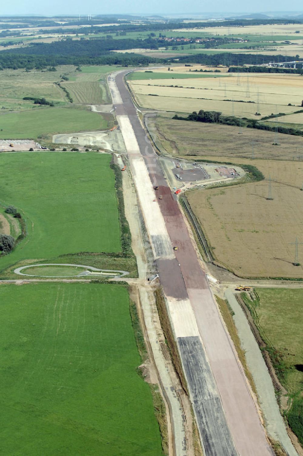 Aerial photograph Wenigenlupnitz - Blick auf die Baustelle einer Unterführung mit Regenrückhaltebecken westlich der südlichen (v) und nördlichen (h) PWC-Anlage / Parkplatz mit WC / Rastplatz der A4 bei Wenigenlupnitz. Der Neubau ist Teil des Projekt Nordverlegung / Umfahrung Hörselberge der Autobahn E40 / A4 in Thüringen bei Eisenach. Durchgeführt werden die im Zuge dieses Projektes notwendigen Arbeiten unter an derem von den Mitarbeitern der Niederlassung Weimar der EUROVIA Verkehrsbau Union sowie der Niederlassungen Abbruch und Erdbau, Betonstraßenbau, Ingenieurbau und TECO Schallschutz der EUROVIA Beton sowie der DEGES.