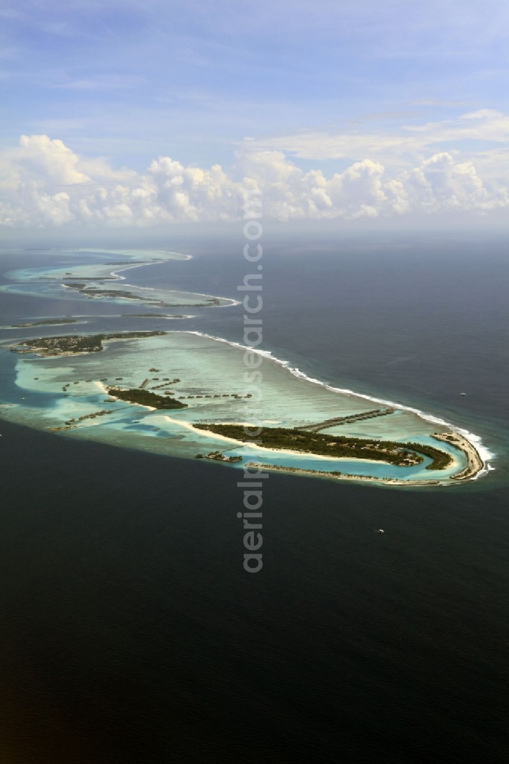 Aerial photograph Dharanboodhoo - Cumulus clouds overcast Coastal Indian Ocean - island in Dhahran Boodhoo in Central Province, Maldives