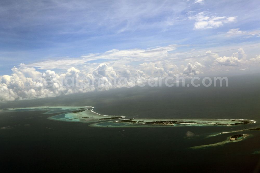 Dharanboodhoo from above - Cumulus clouds overcast Coastal Indian Ocean - island in Dhahran Boodhoo in Central Province, Maldives