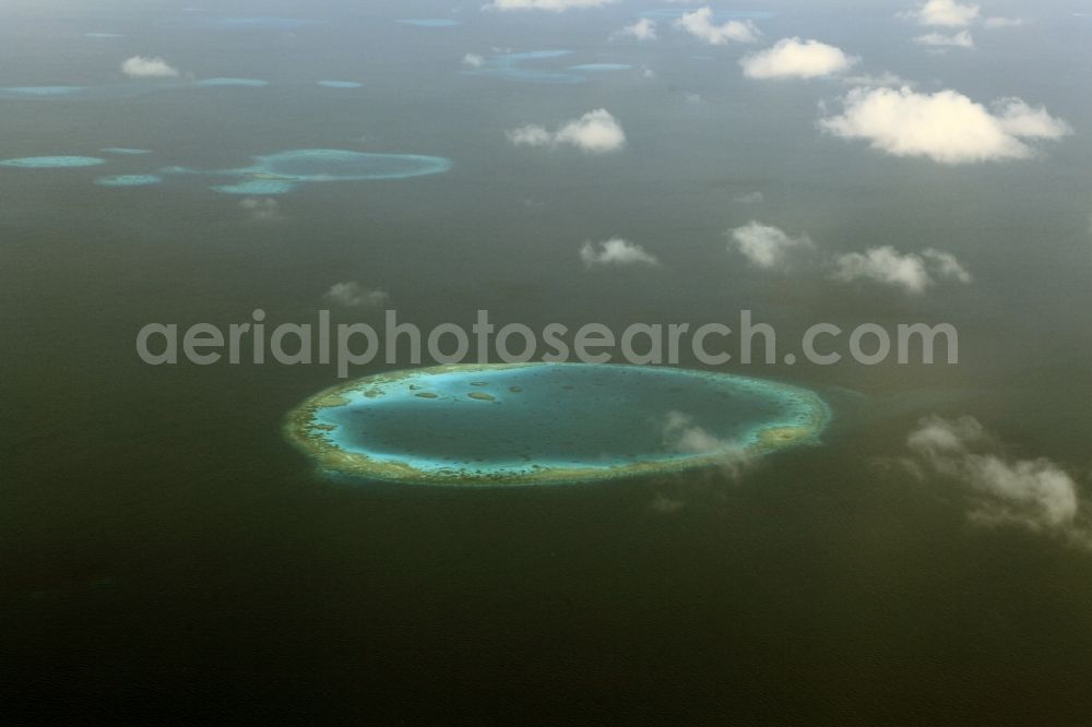 Aerial photograph Dharanboodhoo - Cumulus clouds overcast Coastal Indian Ocean - island in Dhahran Boodhoo in Central Province, Maldives