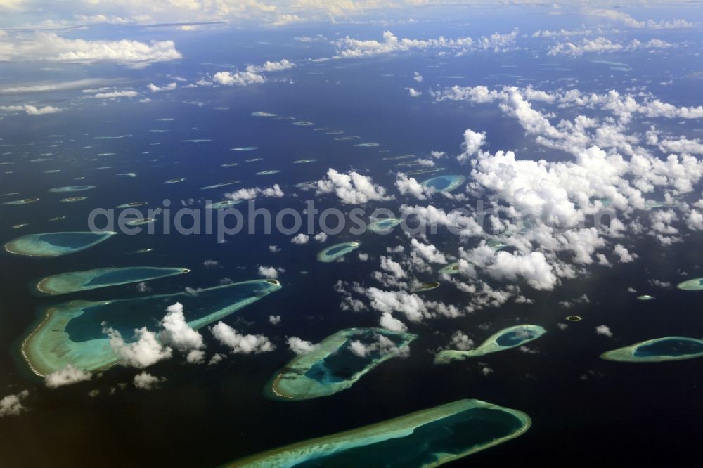 Dharanboodhoo from above - Cumulus clouds overcast Coastal Indian Ocean - island in Dhahran Boodhoo in Central Province, Maldives