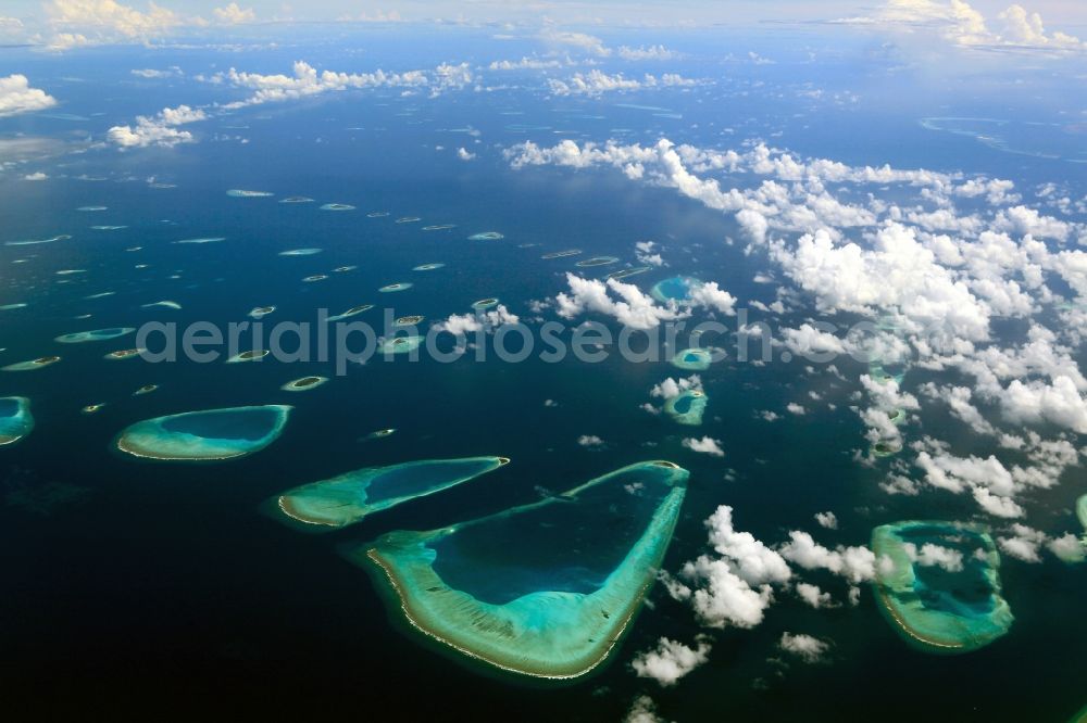 Aerial photograph Dharanboodhoo - Cumulus clouds overcast Coastal Indian Ocean - island in Dhahran Boodhoo in Central Province, Maldives