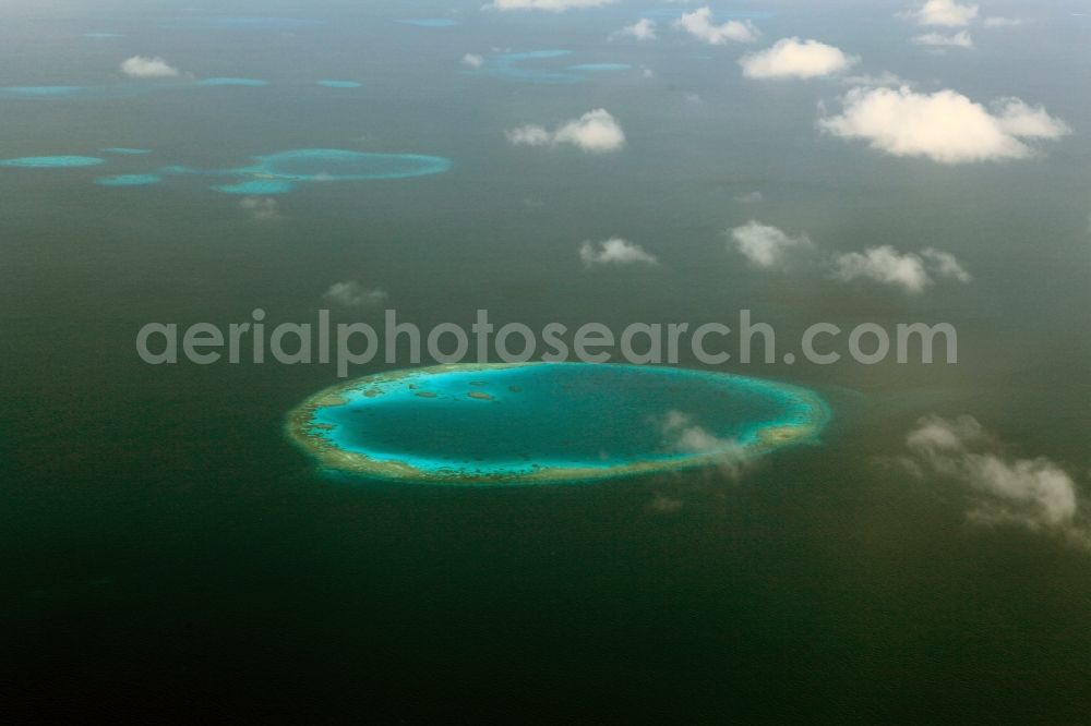 Aerial photograph Dharanboodhoo - Cumulus clouds overcast Coastal Indian Ocean - island in Dhahran Boodhoo in Central Province, Maldives