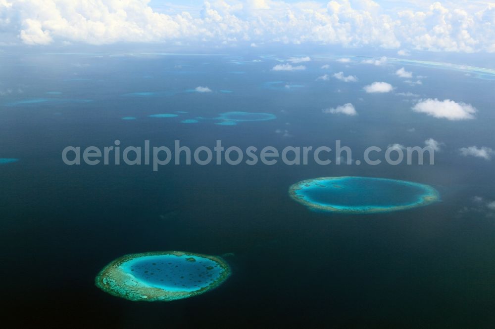 Dharanboodhoo from above - Cumulus clouds overcast Coastal Indian Ocean - island in Dhahran Boodhoo in Central Province, Maldives