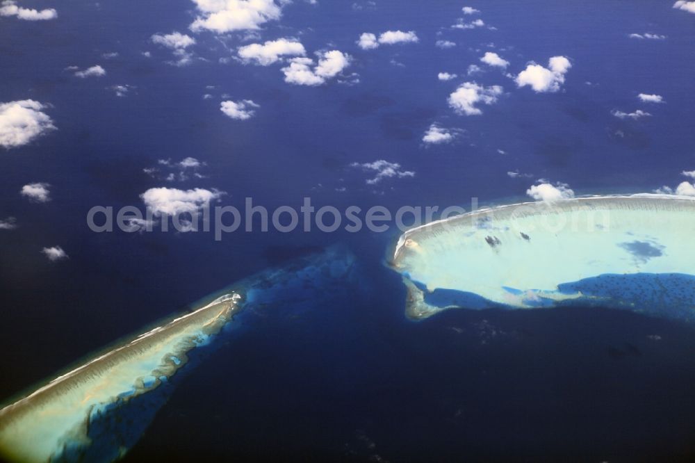 Aerial photograph Dharanboodhoo - Cumulus clouds overcast Coastal Indian Ocean - island in Dhahran Boodhoo in Central Province, Maldives