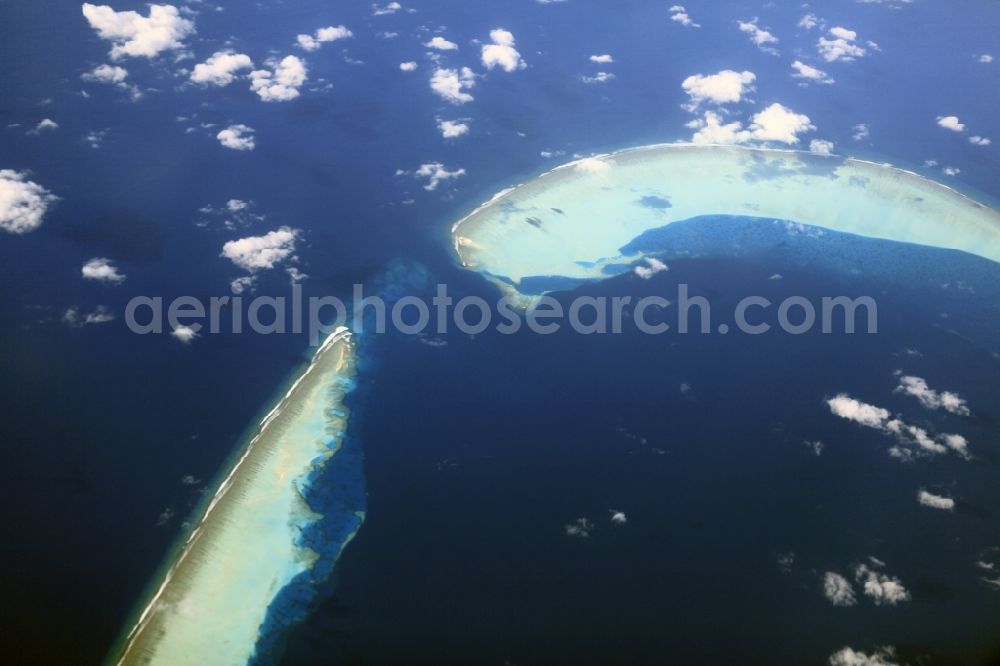 Dharanboodhoo from above - Cumulus clouds overcast Coastal Indian Ocean - island in Dhahran Boodhoo in Central Province, Maldives